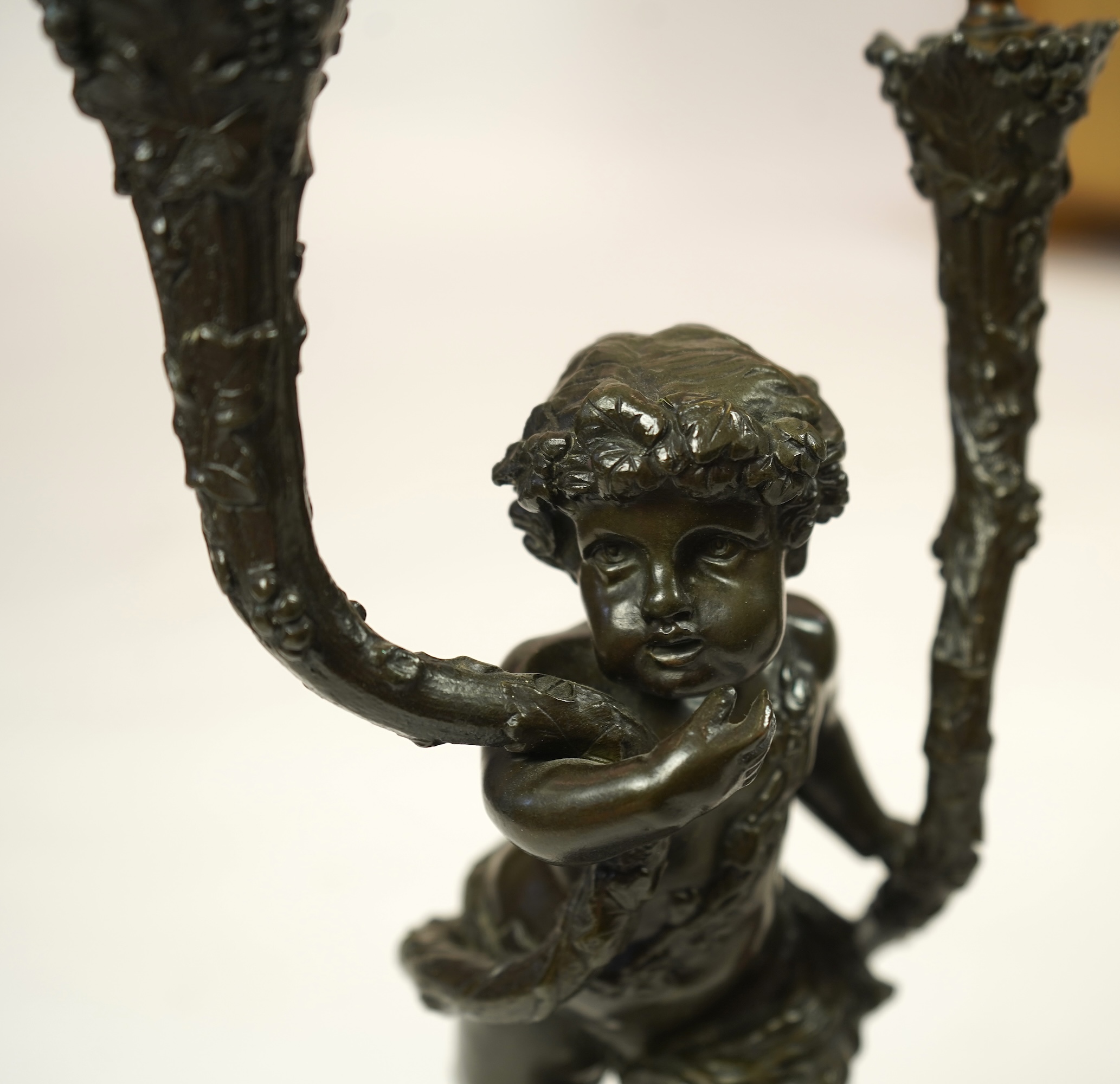 After Clodion. A pair of mid 19th century French bronze two branch figural candelabra